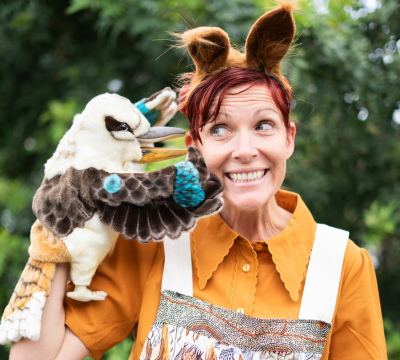 Smiling puppeteer with kookaburra puppet